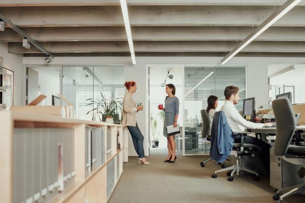 Two women talking in an open office