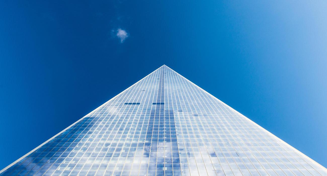 Looking up at a glass building and sky